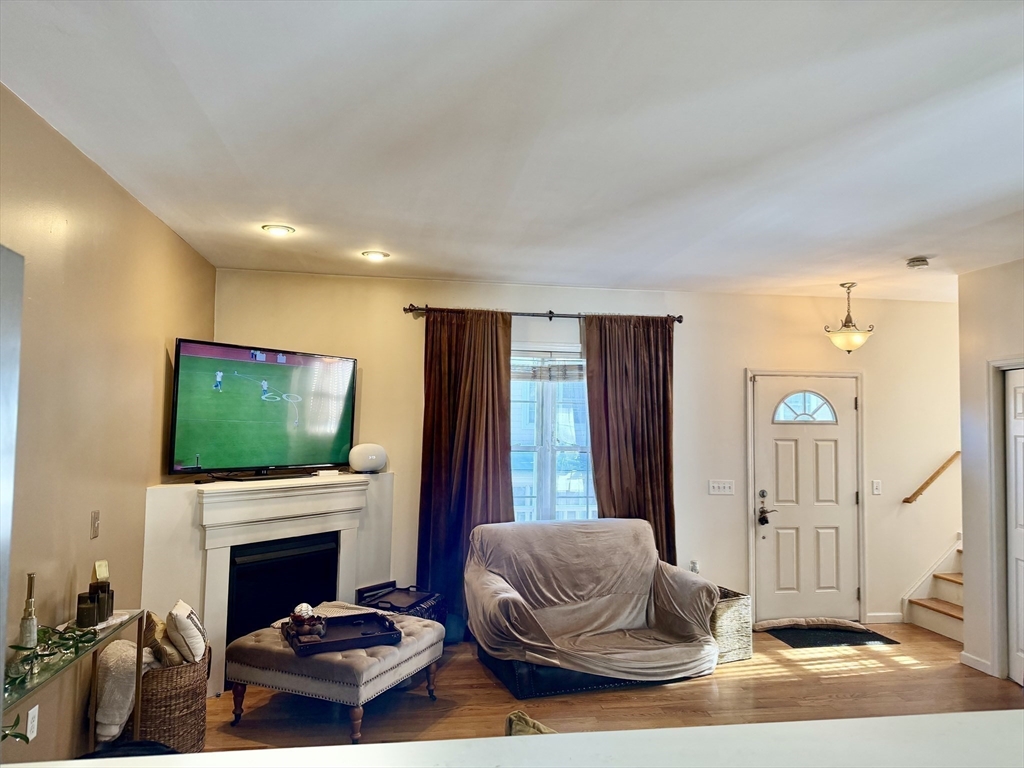 10 Milton Ridge Road, Unit 10 Lynn, MA 01902 - Photo 23 of 33 a living room with furniture a flat screen tv and a fireplace
