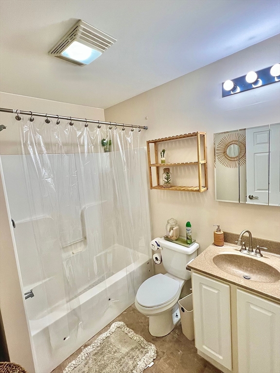 10 Milton Ridge Road, Unit 10 Lynn, MA 01902 - Photo 24 of 33 a bathroom with a granite countertop sink toilet a mirror a bathtub and shower