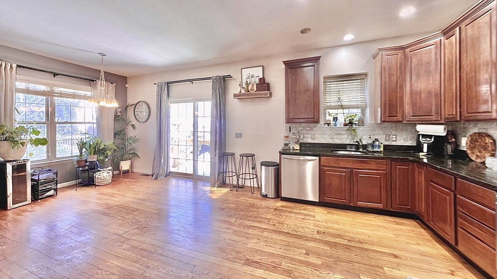 10 Milton Ridge Road, Unit 10 Lynn, MA 01902 - Photo 3 of 33 a large kitchen with wooden floors and stainless steel appliances