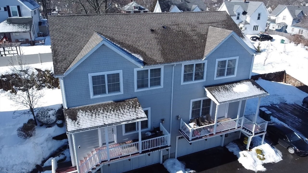 10 Milton Ridge Road, Unit 10 Lynn, MA 01902 - Photo 33 of 33 a front view of a house with a yard garage and outdoor seating