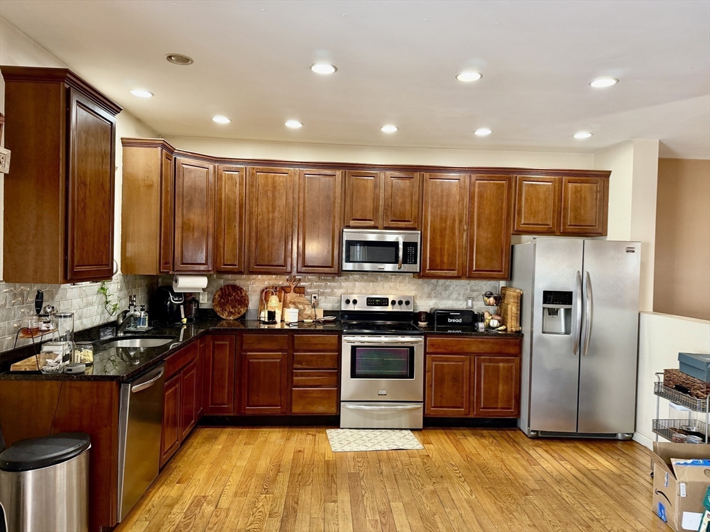 10 Milton Ridge Road, Unit 10 Lynn, MA 01902 - Photo 5 of 33 a kitchen with stainless steel appliances granite countertop a stove a sink dishwasher a refrigerator and a microwave