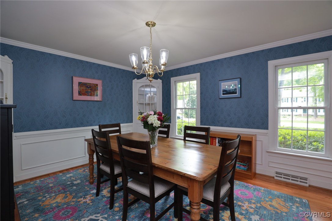 12830 Foxstone Road Midlothian, VA 23113 - Photo 12 of 42 a view of a dining room with furniture a rug and wooden floor
