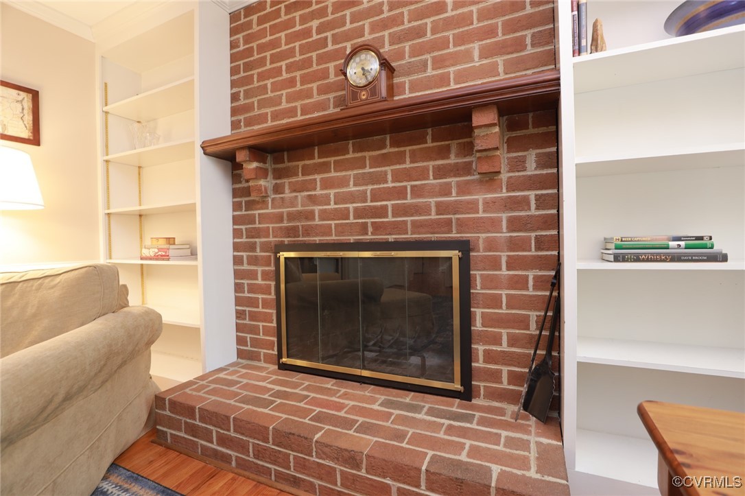 12830 Foxstone Road Midlothian, VA 23113 - Photo 16 of 42 a living room with furniture a flat screen tv and a fireplace