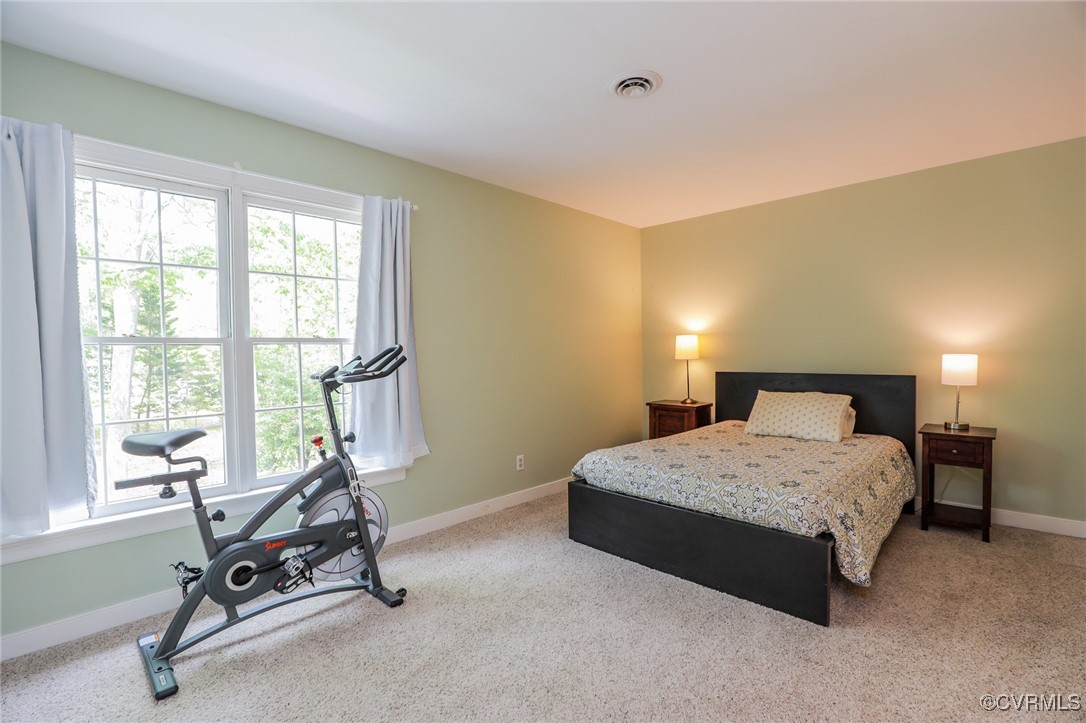 12830 Foxstone Road Midlothian, VA 23113 - Photo 29 of 42 a bedroom with a bed a table and chair