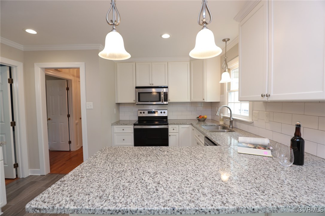 12830 Foxstone Road Midlothian, VA 23113 - Photo 6 of 42 a kitchen with stainless steel appliances granite countertop a stove a sink and a refrigerator