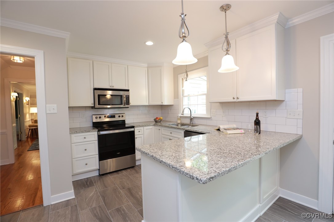 12830 Foxstone Road Midlothian, VA 23113 - Photo 7 of 42 a kitchen with stainless steel appliances granite countertop a sink a stove top oven a counter space and cabinets