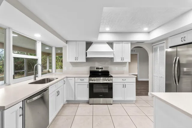a kitchen with a stove a sink and a refrigerator