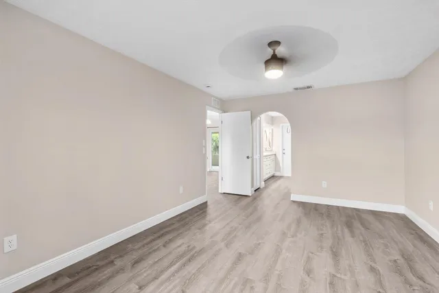 wooden floor in an empty room with a window