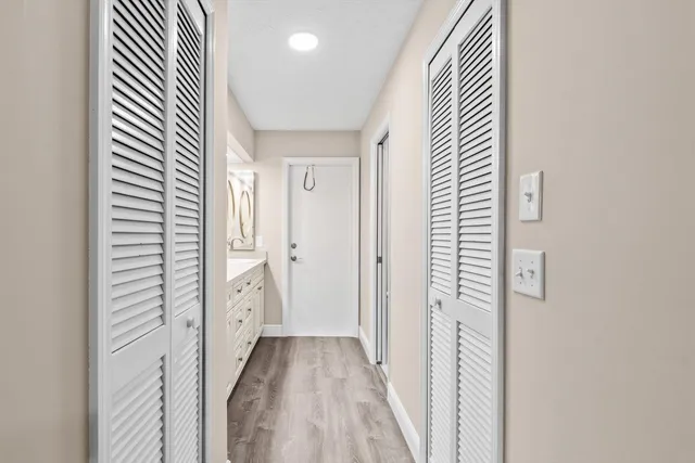 a view of a hallway with wooden floor