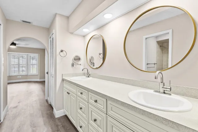 a bathroom with a double vanity sink and a mirror