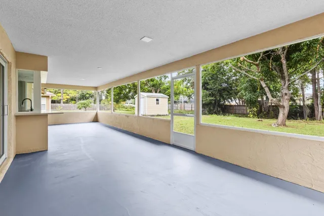 a view of an empty room with a fireplace and a large window