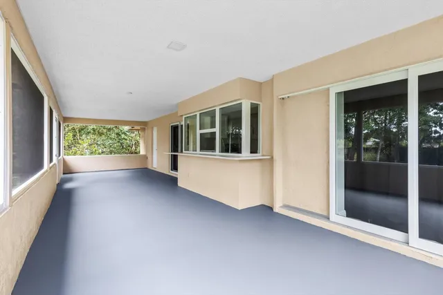 a view of a big room with wooden floor and windows