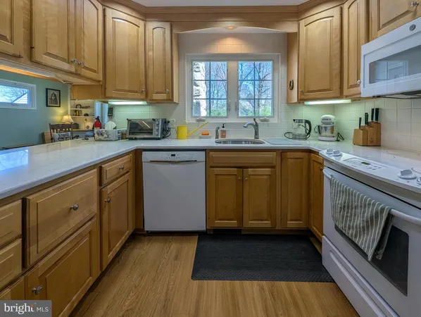 a kitchen with sink cabinets and window