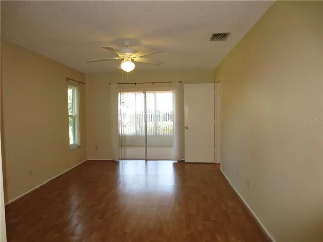 a view of wooden floor and windows in a room