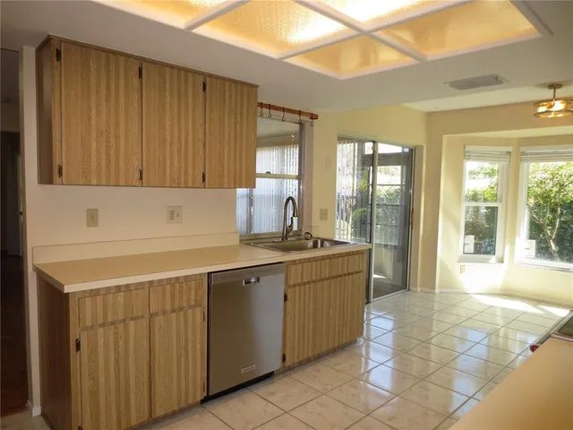 a kitchen with a sink cabinets and window