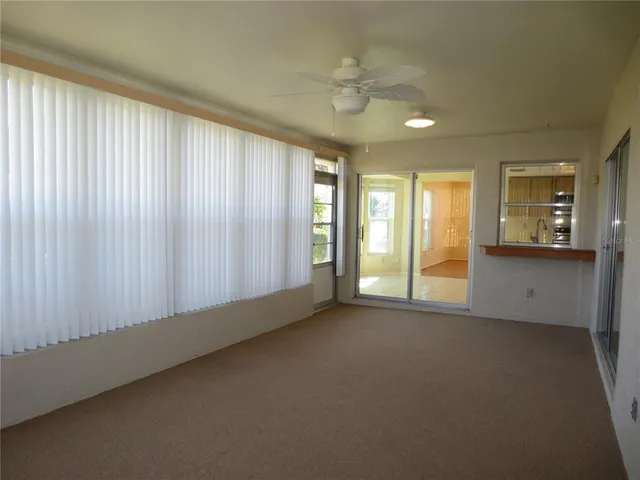 an empty room with a empty space and windows