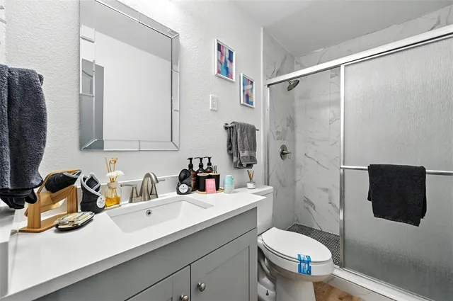 a kitchen with a sink and a flat screen tv