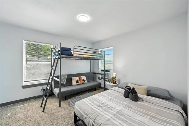 a view of a dining room with furniture a rug and wooden floor