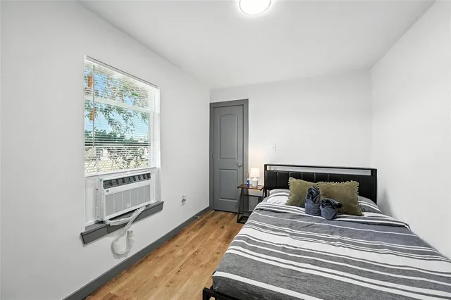 a bedroom with furniture and a window