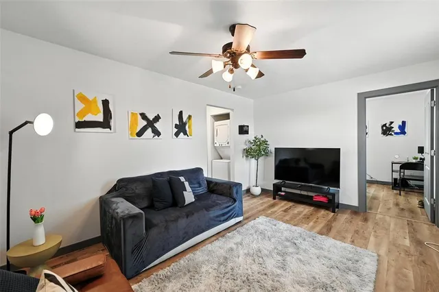 a living room with furniture and wooden floor