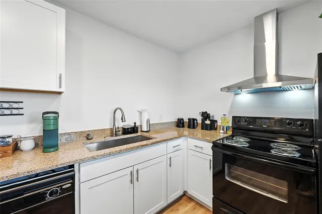 a kitchen with granite countertop stainless steel appliances and sink