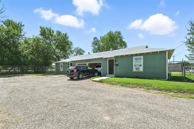 a view of a house with a yard and garage