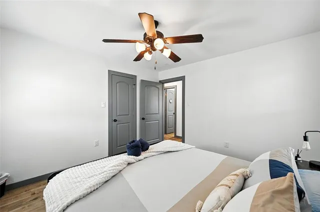 a bedroom with a bed and a chandelier