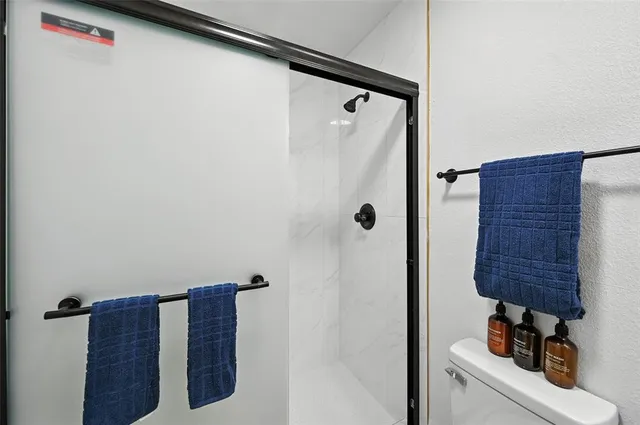 a bathroom with a shower and a mirror