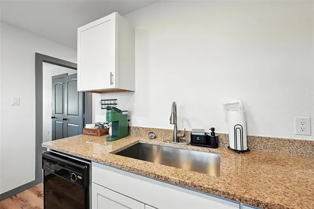a kitchen with cabinets and sink