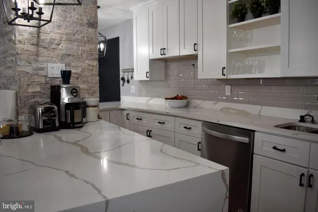 a living room with patio furniture and a garden