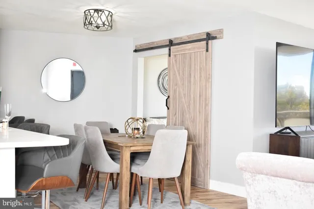 a view of a swimming pool with a bench and trees in the background