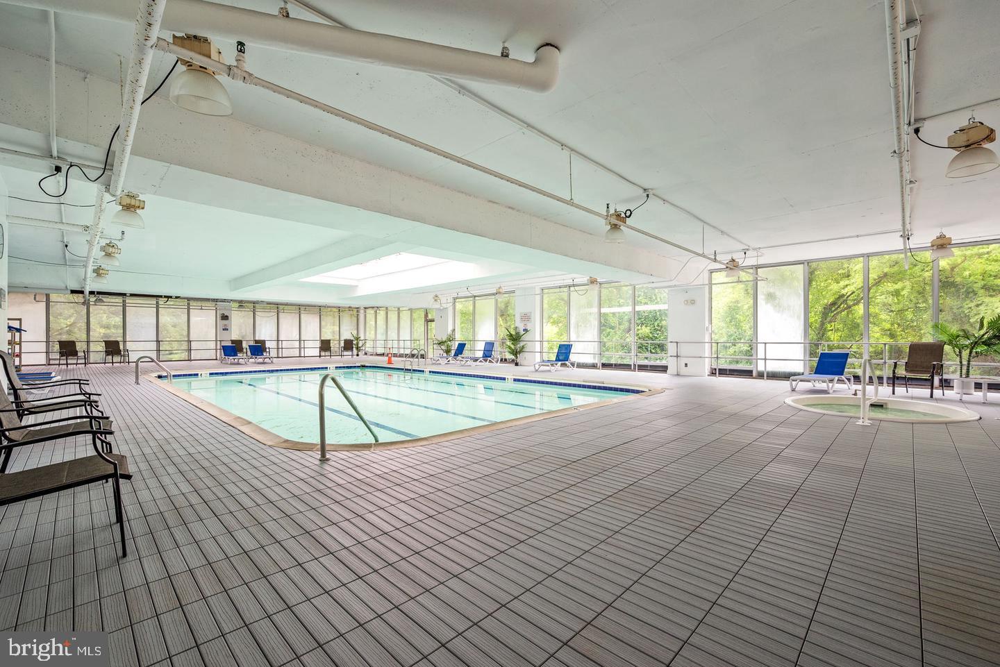 3900 West Ford Road, Unit 14K Philadelphia, PA 19131 - Photo 38 of 53 Serene indoor pool with natural light.