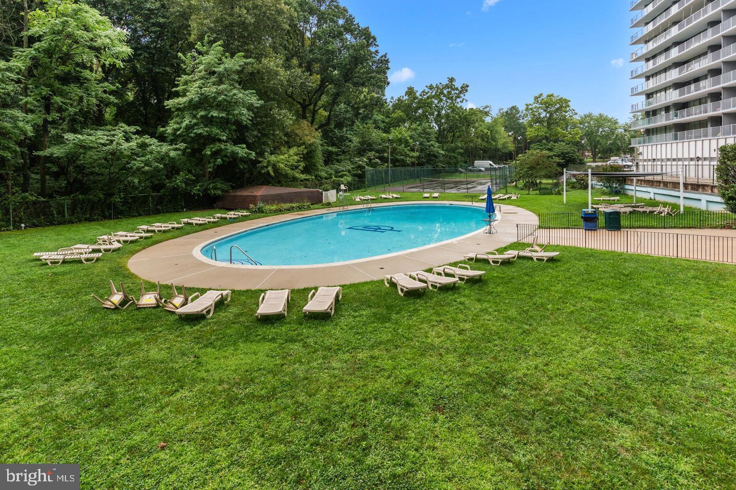 3900 West Ford Road, Unit 14K Philadelphia, PA 19131 - Photo 42 of 53 Serene poolside oasis surrounded by greenery.