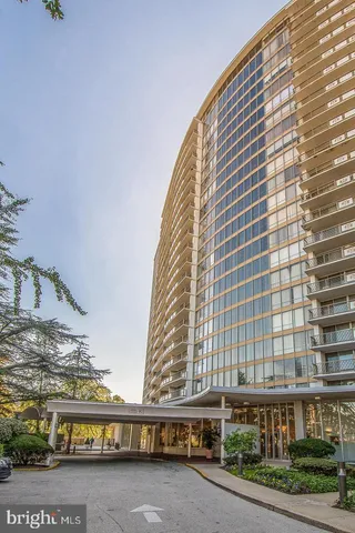 a view of a lobby with floor to ceiling windows and ceiling fan