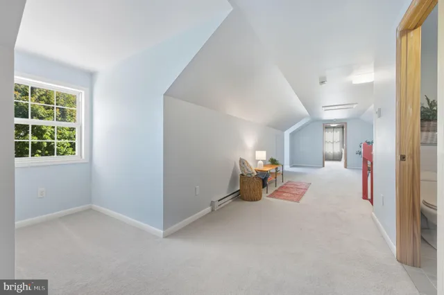 a bedroom with furniture and a chair