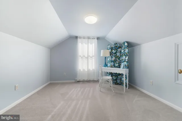 a dining room with furniture and a window