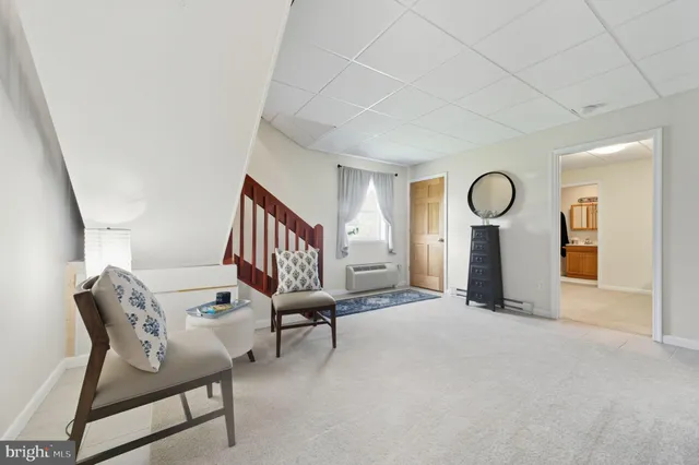 a view of a livingroom with furniture and a window