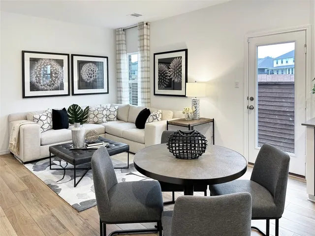 a living room with furniture a rug and a window