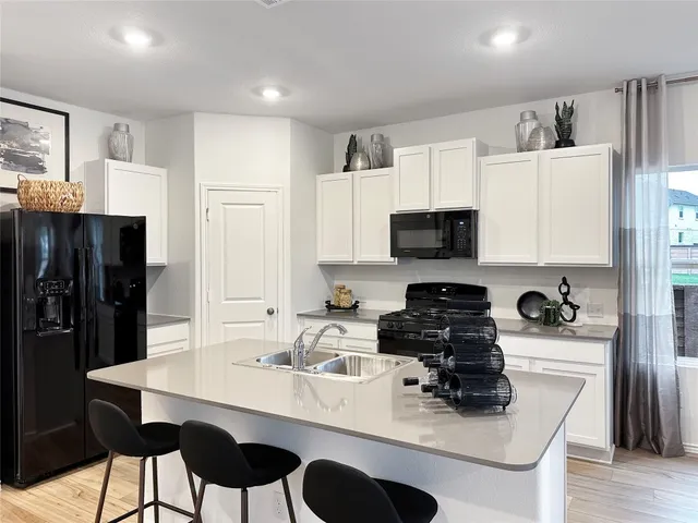 a kitchen with a sink a stove and refrigerator