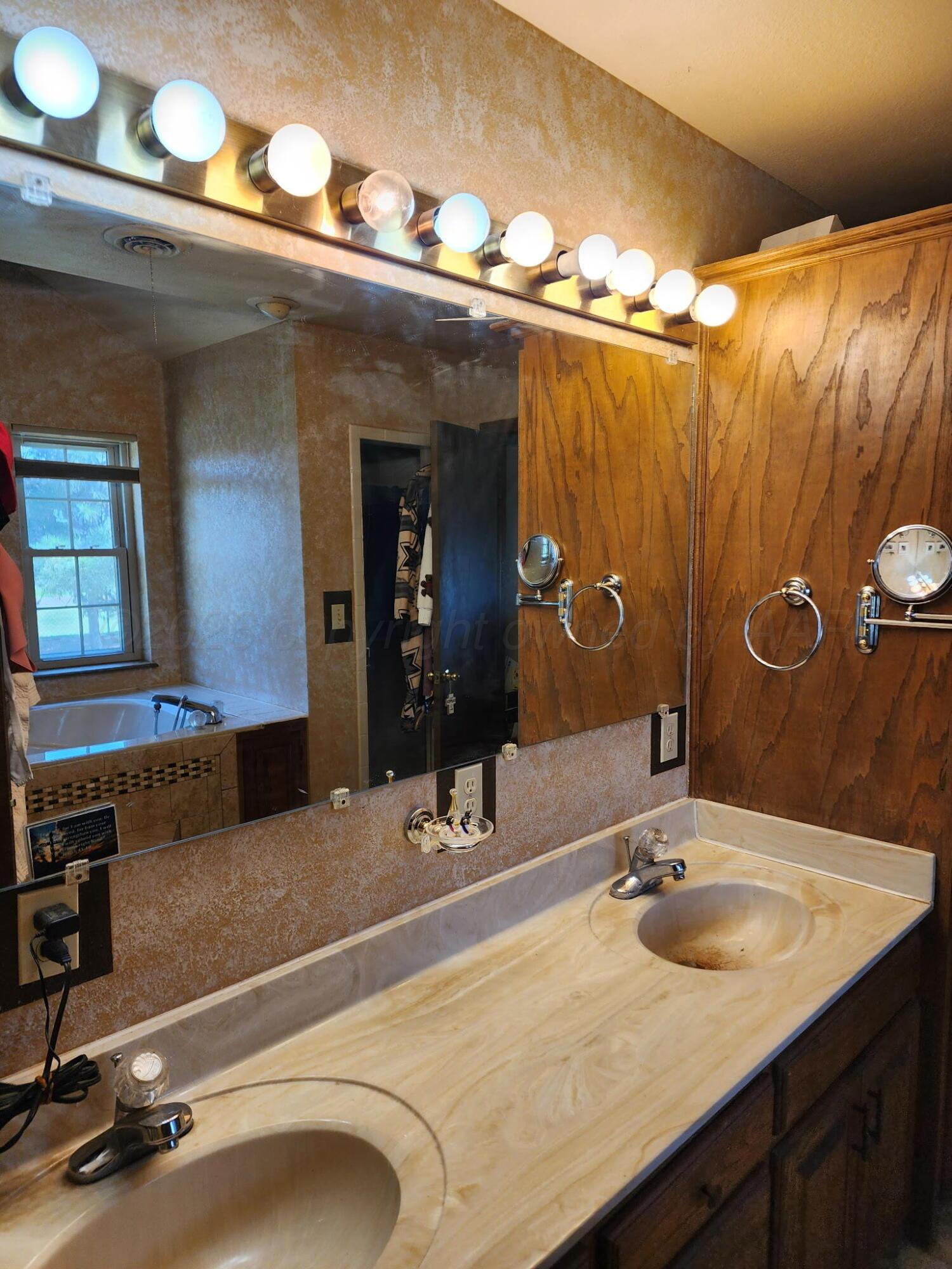 16700 Old Ranch Road Canyon, TX 79015 - Photo 24 of 54 a bathroom with a sink and a mirror