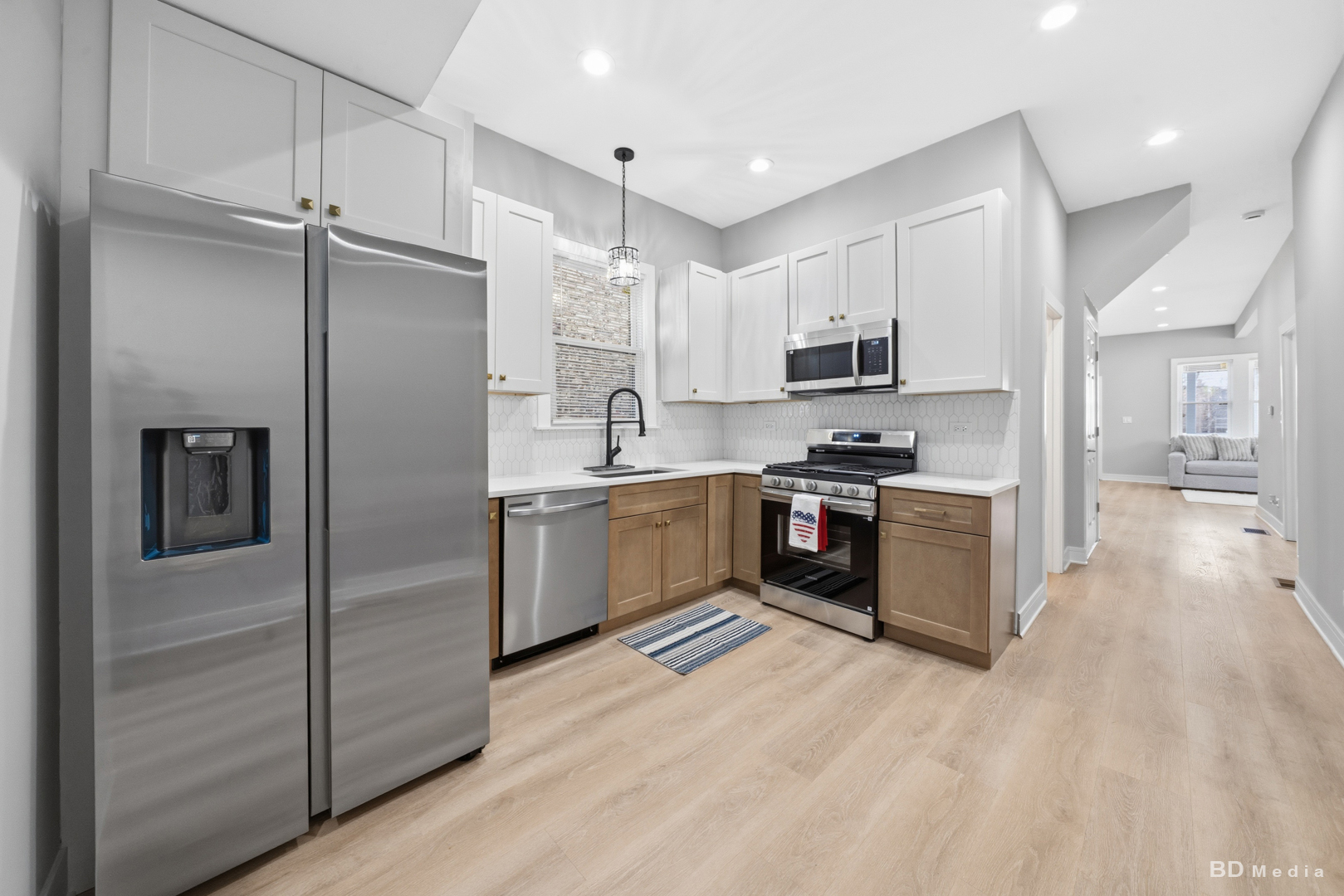 7307 South Peoria Street Chicago, IL 60621 - Photo 14 of 45 a kitchen with stainless steel appliances cabinets a sink and a refrigerator
