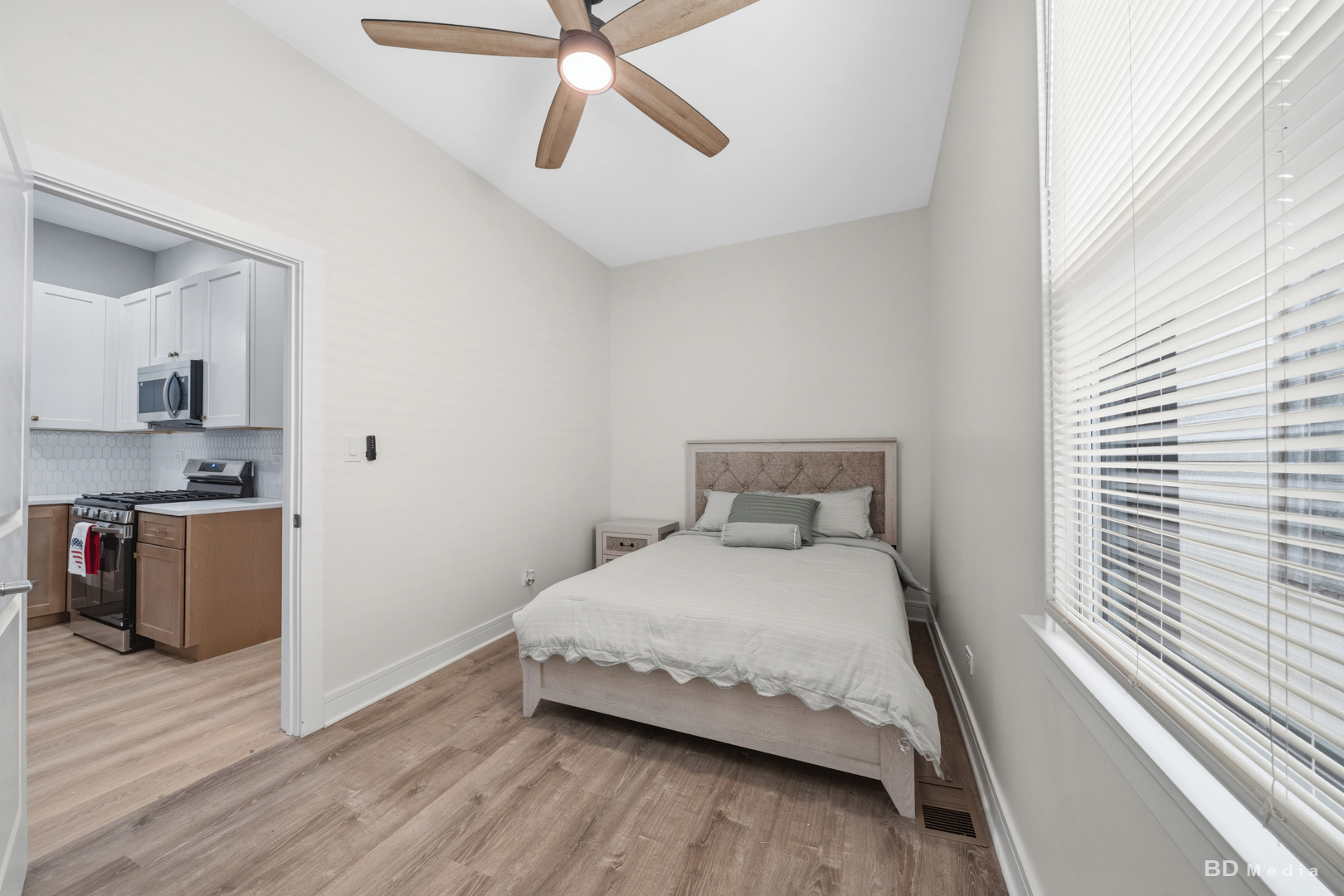 7307 South Peoria Street Chicago, IL 60621 - Photo 16 of 45 a bedroom with a bed and a chandelier