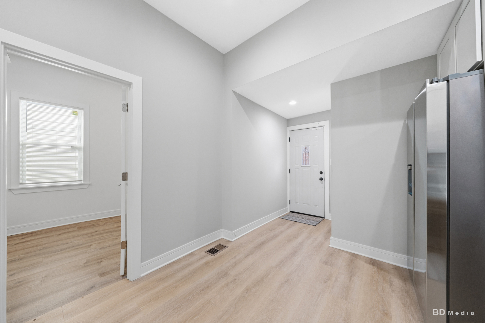 7307 South Peoria Street Chicago, IL 60621 - Photo 17 of 45 a view of an empty room with wooden floor and a window