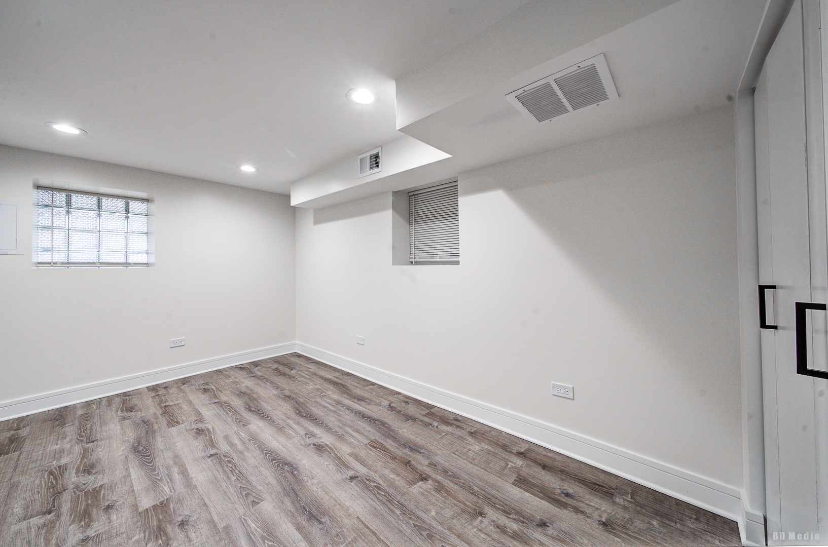 7307 South Peoria Street Chicago, IL 60621 - Photo 27 of 45 an empty room with wooden floor and windows
