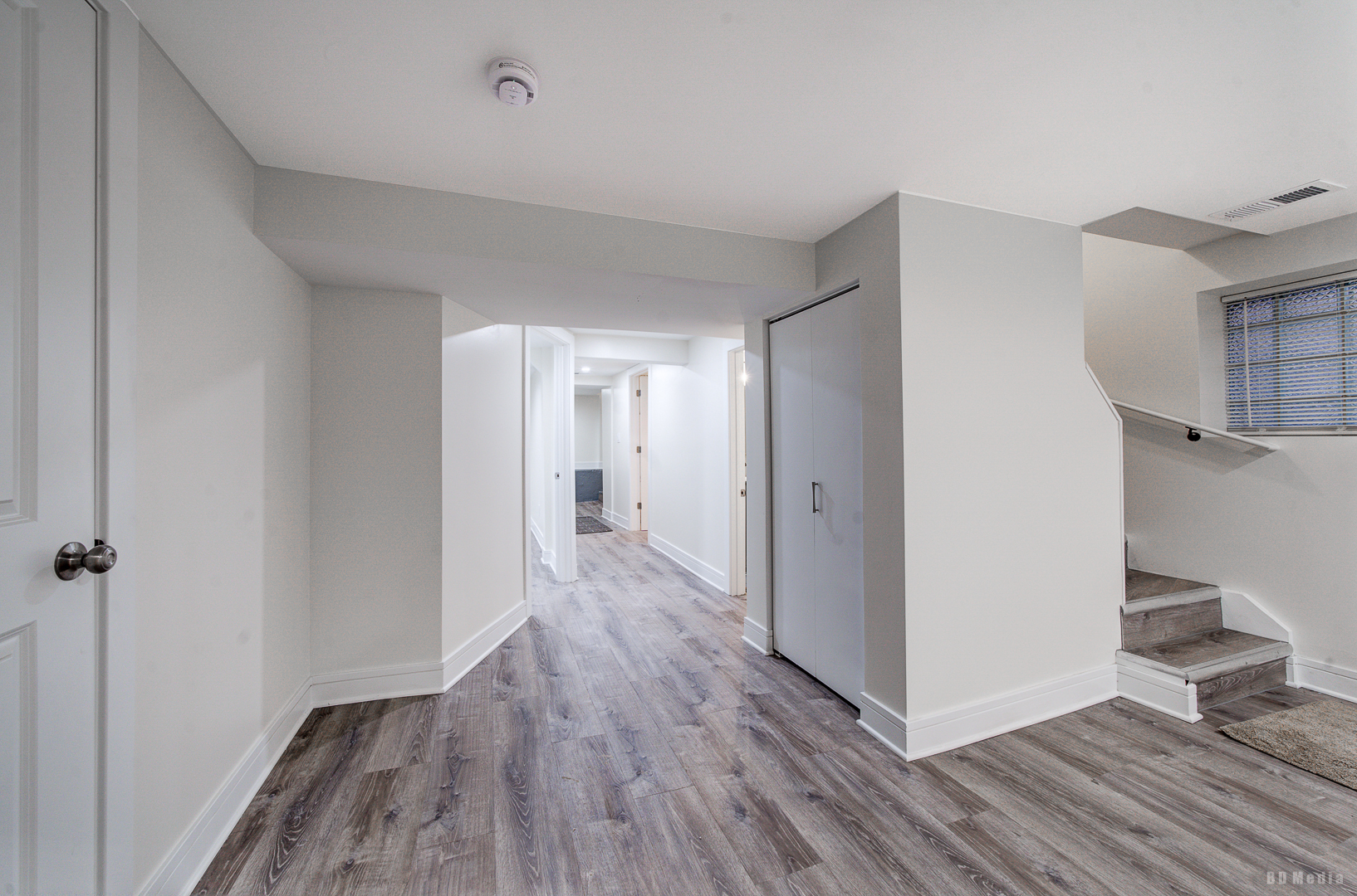 7307 South Peoria Street Chicago, IL 60621 - Photo 29 of 45 a view of a hallway with wooden floor and a bathroom