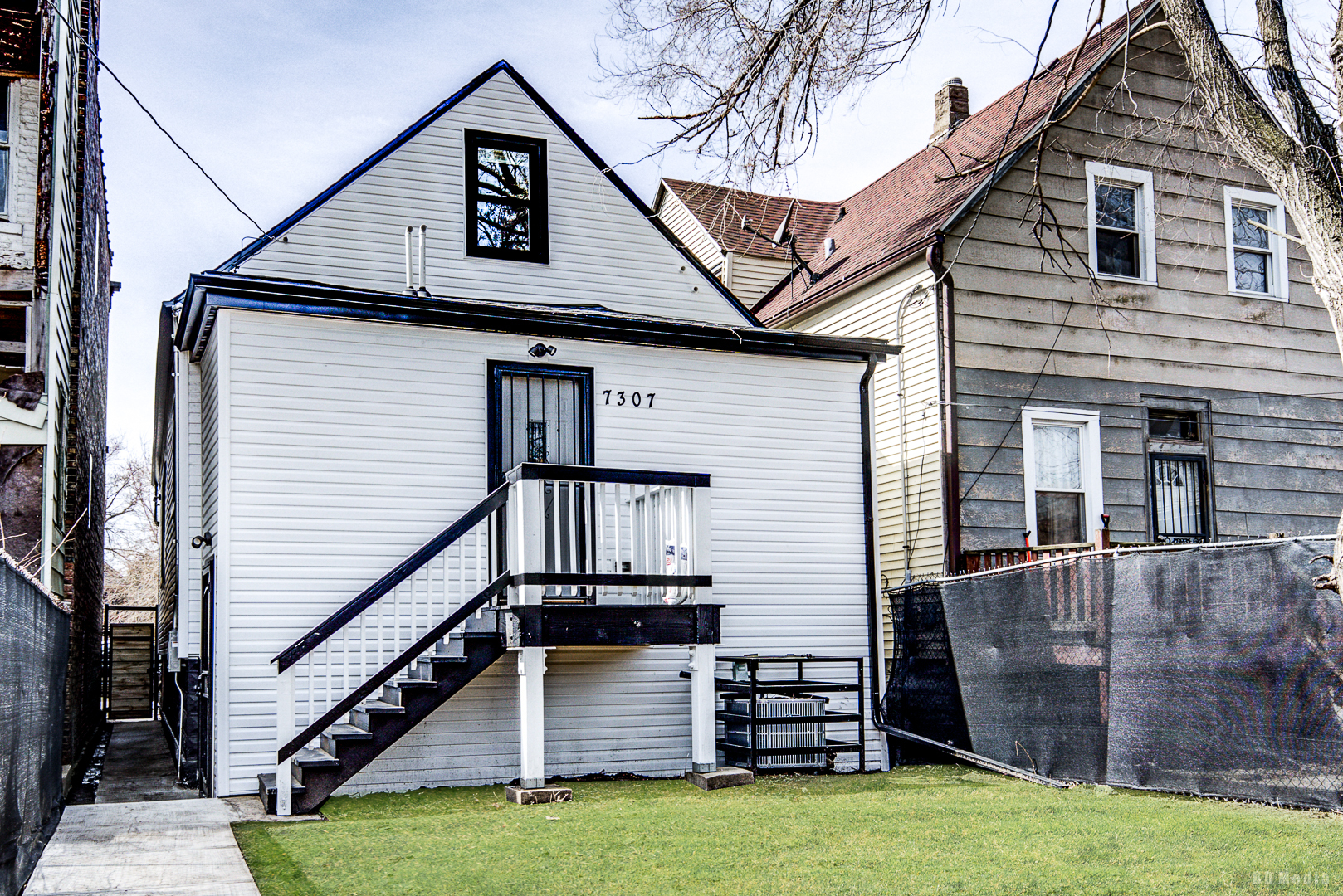7307 South Peoria Street Chicago, IL 60621 - Photo 35 of 45 a view of a house with wooden stairs and a small yard