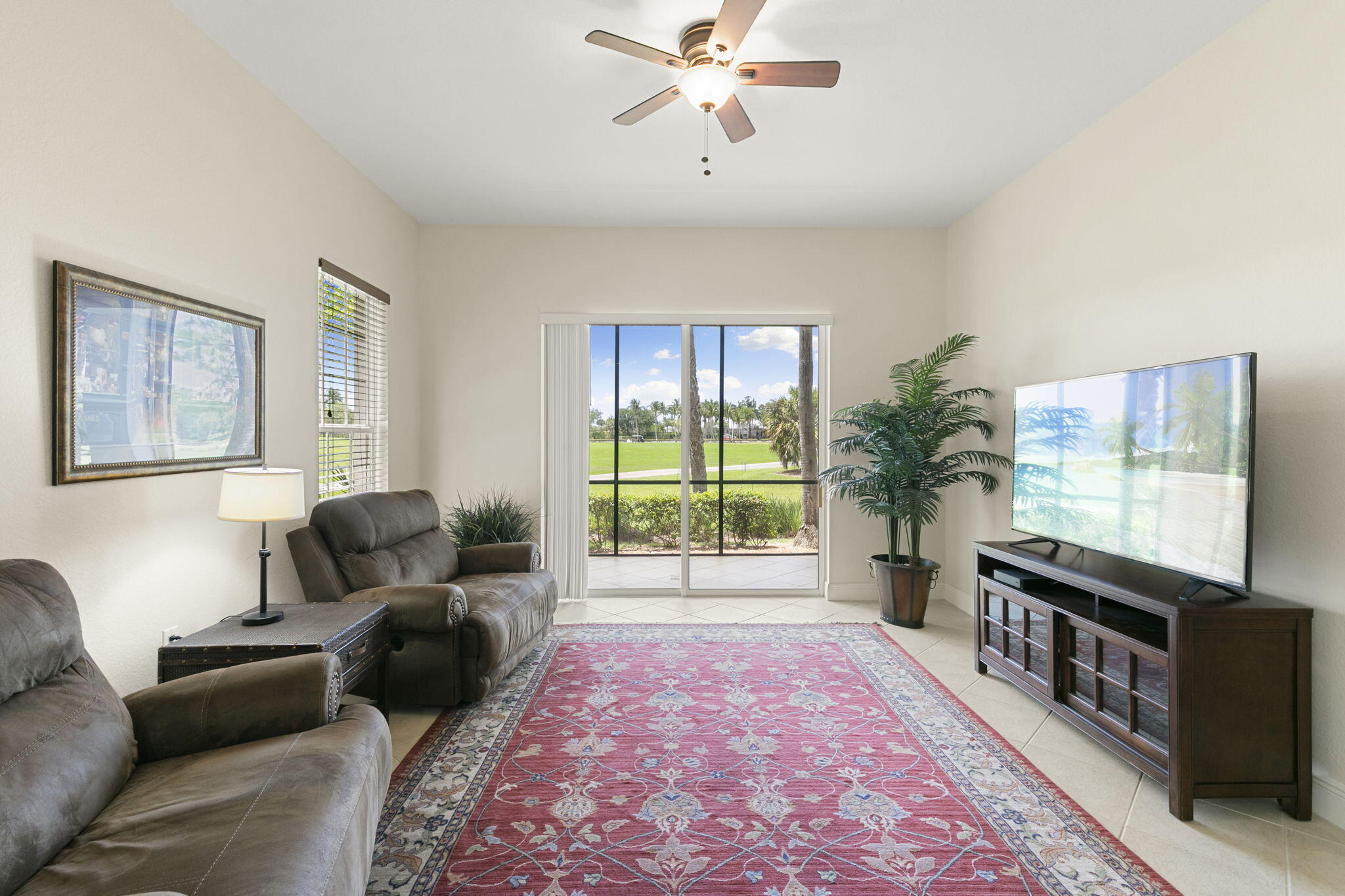 9066 Cascada Way, Unit 101 Naples, FL 34114 - Photo 11 of 51 a living room with furniture and a flat screen tv