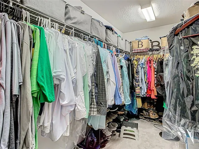 a bathroom with a granite countertop sink a large mirror and a shower