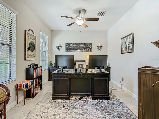 a view of a workspace with furniture and a window