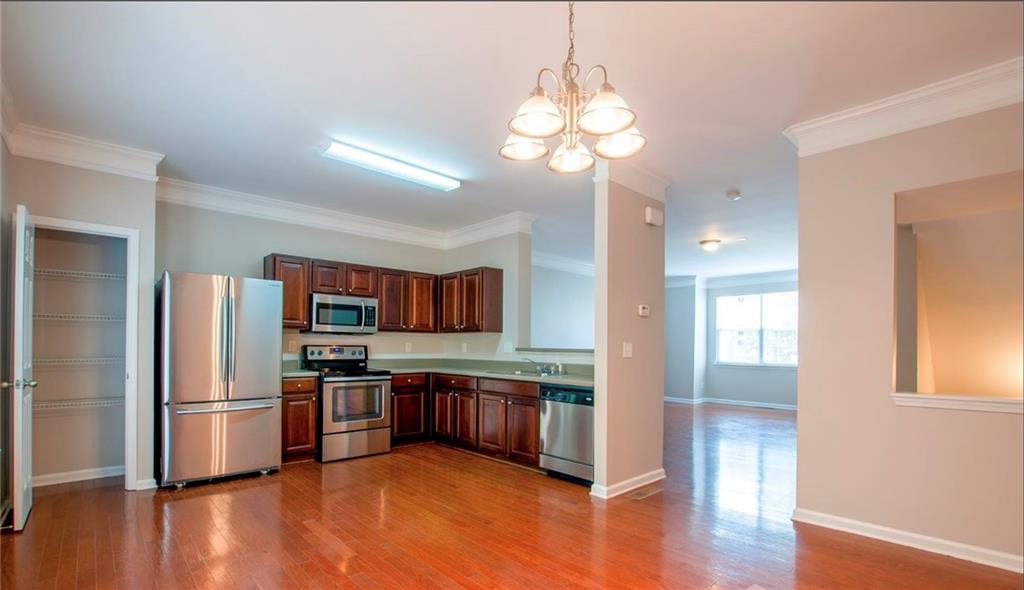 6764 Blackstone Place, Unit 6 Mableton, GA 30126 - Photo 1 of 1 a kitchen with stainless steel appliances kitchen island granite countertop a refrigerator and a stove top oven